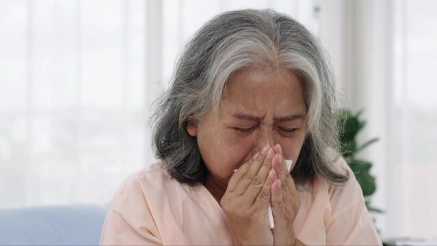 Elderly Asian patient admitted to hospital She had a violent cough while sitting on the hospital bed.