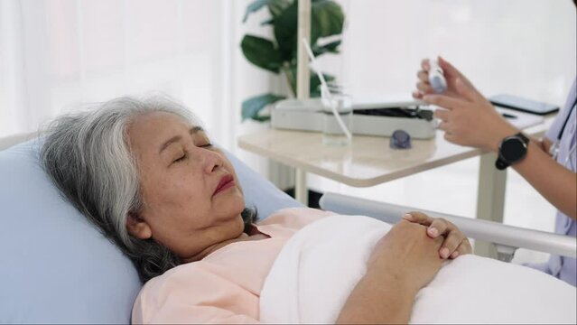 Nurse uses a digital thermometer to take patient temperature.