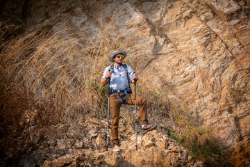 Tourists with backpacks hike on rocky of top mountain trekking is adventure activity sport for Traveller who love hike on summer holidays trekking and activity