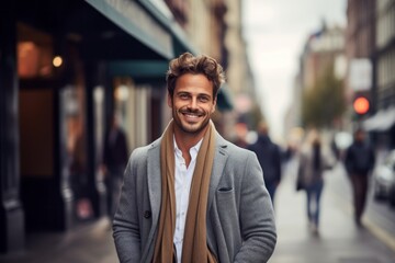 Obraz premium Portrait of a grinning man in his 30s wearing a chic cardigan against a busy urban street. AI Generation