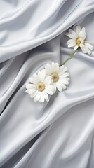 Pearl grey silk fabrics with a scattering of delicate daisies and silver leaves. Vertical orientation. 