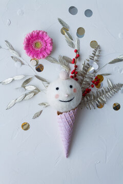 Flat lay of funny christmas decoration with snowman, confetti and flowers