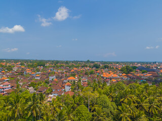 Aerial drone view of the Ubud historical city center with temples and many red roof houses in cultural center of Bali, Indonesia