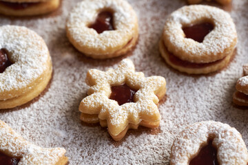 Star shaped Linzer Christmas cookie filled with strawberry marmalade, dusted with sugar