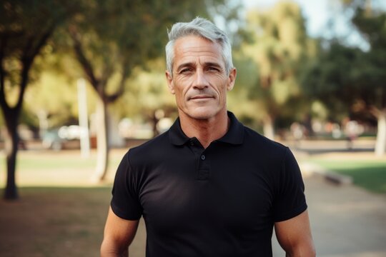 Portrait of a content man in his 50s donning a classy polo shirt against a vibrant city park. AI Generation