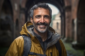 Portrait of a smiling man in his 50s sporting a waterproof rain jacket against a backdrop of ancient ruins. AI Generation