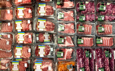 Meat at supermarket Steaks, Pork chops, ribeye at supermarket refrigerator. View from above....