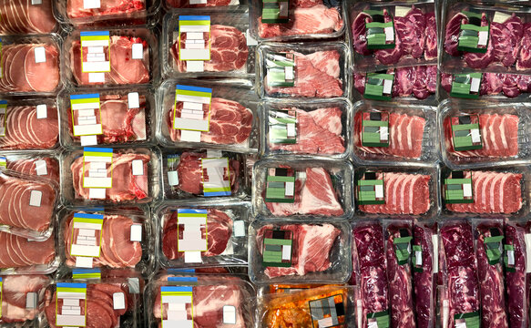 Meat at supermarket Steaks, Pork chops, ribeye at supermarket refrigerator. View from above. Brand-less packaging mockup and illustration ideal for graphic designers, architects and interior designers