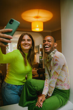 Happy moment of two young multiracial adults taking a selfie