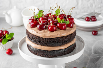 Naked Black forest cake, Schwarzwald pie. Cake with dark chocolate, cream and cherry on a gray...
