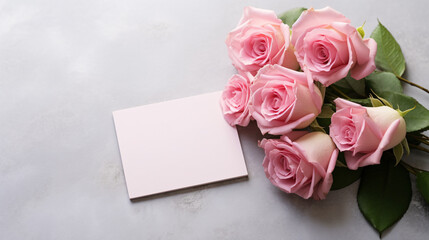 Beautiful pink rose flower bouquet and mockup blank note paper on gray background, congratulations and anniversary concept, Valentine s day background.