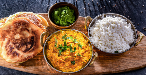 Curry chicken with rice served in original indian karahi pots