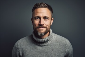 Obraz premium Portrait of a glad man in his 30s wearing a cozy sweater against a pastel gray background. AI Generation