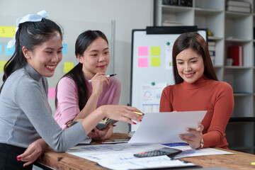 Happy Asian businesswoman working together in office Brainstorming meeting of the online internet technology creative team Business partners or teamwork concept of colleagues in office.