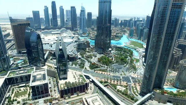 Dubai, United Arab Emirates: Aerial panoramic view of urban modern district at blue sky of Dubai city, UAE. Cityscape with Burj Khalifa, daytime. Construction architecture concept. 4K