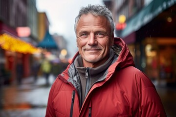 Fototapeta premium Portrait of a merry man in his 50s donning a durable down jacket against a vibrant market street background. AI Generation
