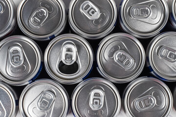metal beer cans background, one can is open. top view