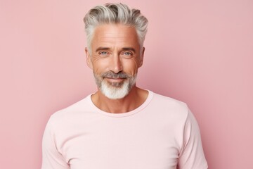 Portrait of a satisfied man in his 50s donning a trendy cropped top against a pastel or soft colors...