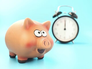 it's time to save. background with piggy bank and alarm clock