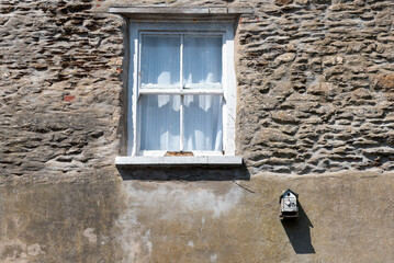 Birdhouse outside old cottage