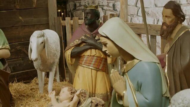 Sculptures of Christian figures in Nativity scene exhibit in Christmas market. Famous religious scene from Christian Bible is seen in outdoors fair or Bible center depicting Christ story