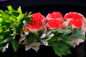 Sandwiches with red caviar, decorated with herbs on a dark background. Delicious Healthy food Breakfast lunch dinner