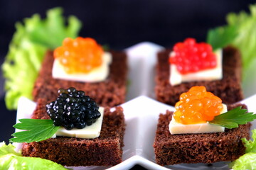  Black red caviar on sandwiches, decorated with greenery. Restaurant food breakfast dinner lunch