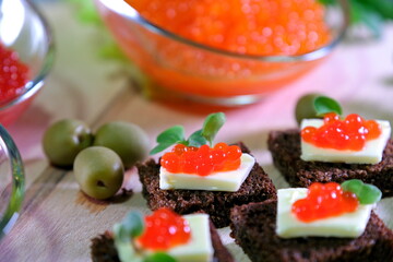  Black red caviar on sandwiches, decorated with greenery. Restaurant food breakfast dinner lunch