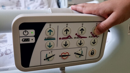 Caucasian kid changing the position of his electrical hospital bed - 680558481