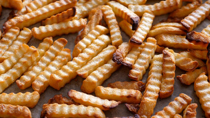 Baked french fries lying on baking paper - 680558607