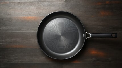 new frying pan on the table. - obrazy, fototapety, plakaty