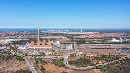 Aerial view of a coal-fired power plant in the city of Sines, in background the sea in Portugal and...