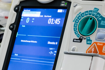 Defibrillator sitting ready for use on a hospital Crash Trolley.