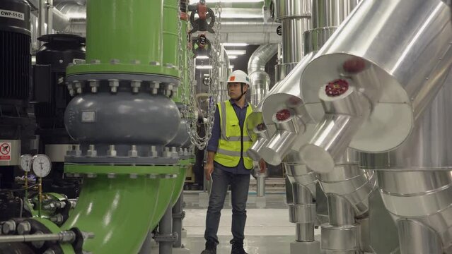 Mechanical engineer Checking of centrifugal pump in pump room. worker working in plant room.