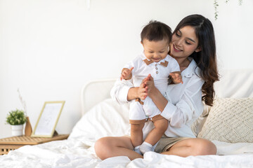 Portrait of enjoy happy love family asian mother playing with adorable little asian baby.Mom...