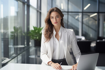 Beautiful businesswoman focused on her work in a sleek, modern office environment