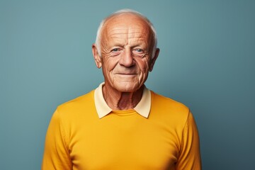 Obraz premium Portrait of a glad man in his 70s donning a classy polo shirt against a solid color backdrop. AI Generation