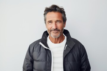 Obraz premium Portrait of a merry man in his 50s sporting a long-sleeved thermal undershirt against a plain white digital canvas. AI Generation