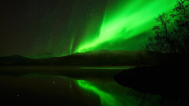 A beautiful and powerful green reflecting aurora transitioning to red for a brief moment during a substorm in October.