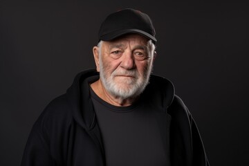 Obraz premium Portrait of a satisfied man in his 70s sporting a comfortable hoodie against a plain cyclorama studio wall. AI Generation