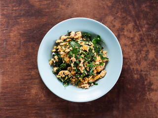 top view Bai Liang Pad Kai, stir fried Malindjo or Baegu leaves with egg, popular Thai southern dish
