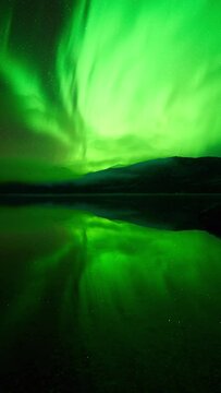 Strong reflections of an aurora in a silent lake in October.