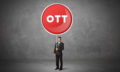 Fototapeta premium Young business person holdig traffic sign