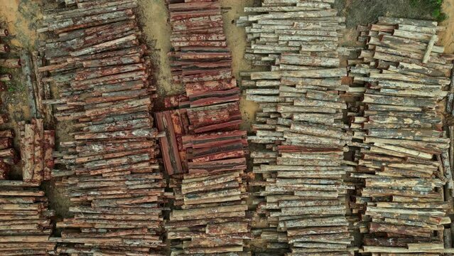 Aerial drone footage: Zooming out on a timber stack of a sustainable forestry project in the brazilian Amazon rainforest