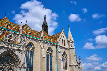 Close ups of the decorative roof with orange and green colors, windows and spires of the...