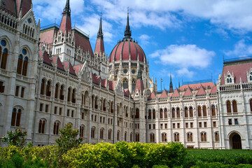 Fototapeta na wymiar Hungarian Parliament Building on a summer day with green bushes in foreground in central Budapest, Hungary.