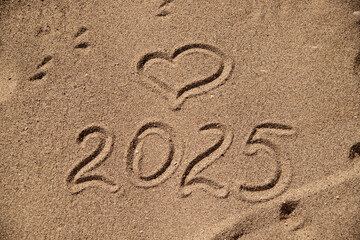 Fototapeta na wymiar 2025 Drawn on Sand in Summer