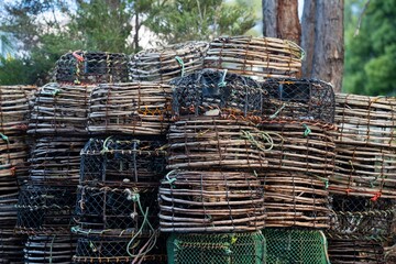 crayfish cray pots stacked up in tasmania australia in spring