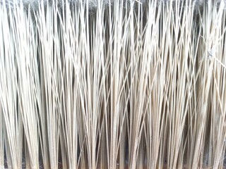 Vertical stripes pattern and texture of brown broom plastic bristles. Close up. Concept photo for background, texture or pattern object.