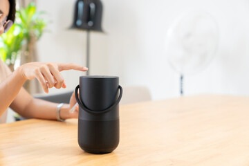 Home modern technology concept, smart portable wireless speaker on the table.